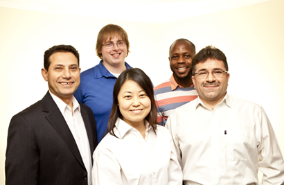 Four men and one woman pose together for a portrait.