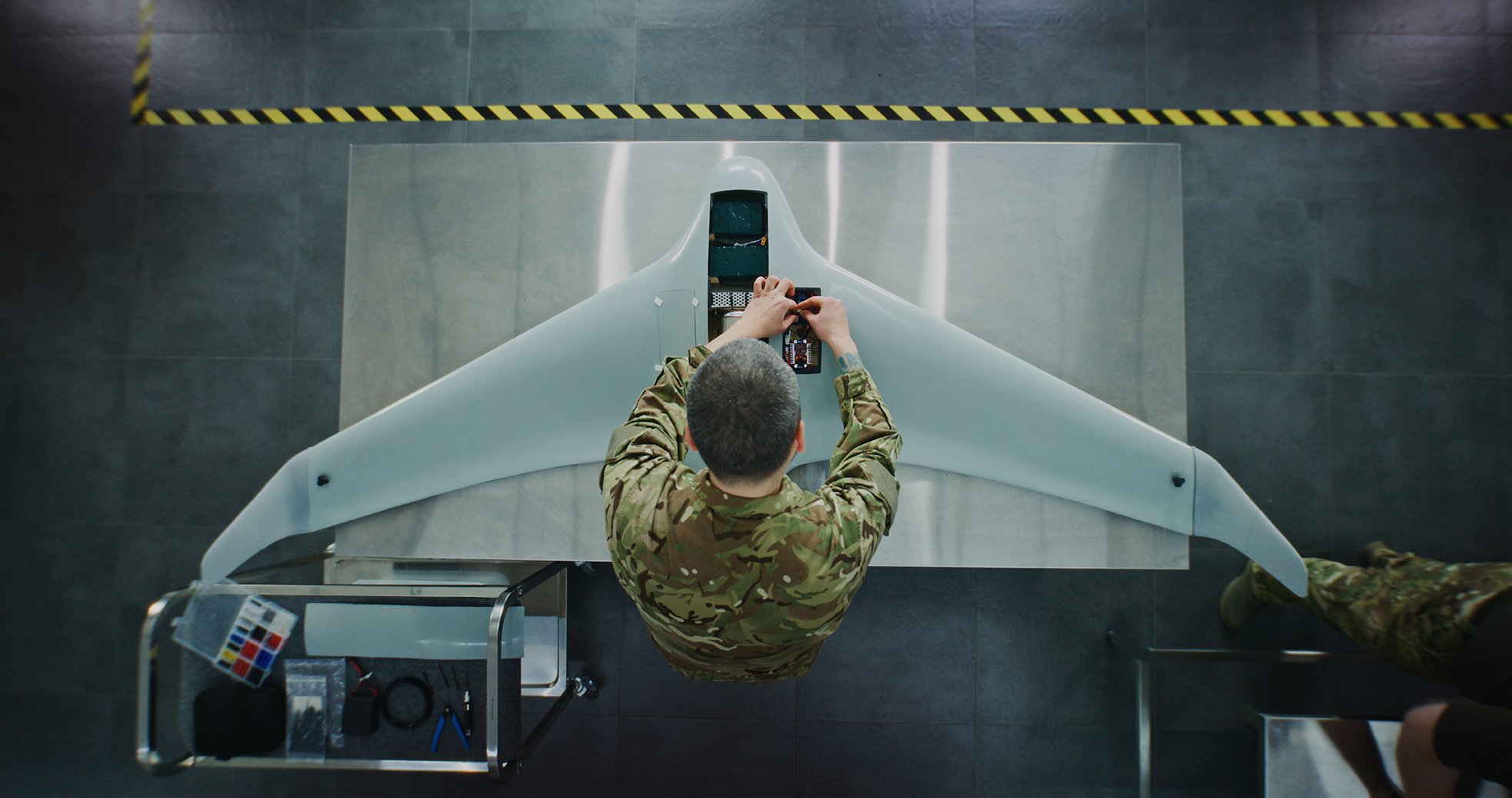 Engineer in Military Uniform Assembling Unmanned Aerial Vehicle
